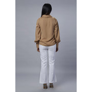 Colette beige cowl neck top Back view with white pant.